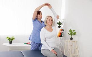 Physiotherapy, sport injury rehabilitation treatment. Woman having chiropractic back adjustment. Osteopathy, Alternative medicine, pain relief concept. photo