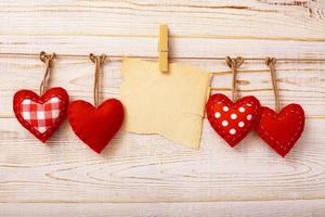 Valentines Vintage Handmade Hearts over Wooden Background. photo