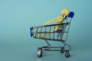 creative minimalist composition, a skeleton riding on a supermarket cart, turquoise background, a skull photo