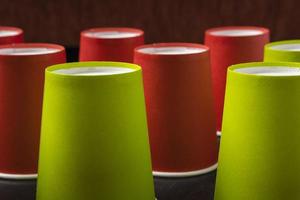 Creative minimalistic composition, pattern of inverted paper cups on a black background, coffee, ecology concepts photo