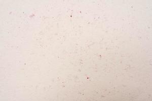 Laconic beige background with red flecks, cream background photo