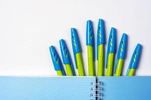 Notepad and pens on a white background, stationery photo