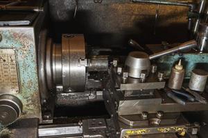 Old metal lathe in the workshop, metalworking, machine tools photo