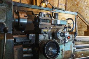 Old metal lathe in the workshop, metalworking, machine tools photo