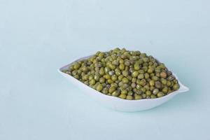 view negative space small bowl of green peas photo