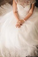 Bride hand on wedding dress. selective focus. wedding day photo