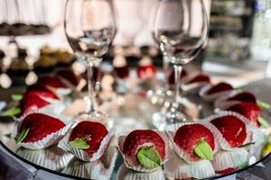 delicious candy bar at luxury wedding reception. exclusive expensive catering. table with modern desserts, cupcakes, sweets with fruits. baby or bridal shower. holiday celebration. selective focus. photo