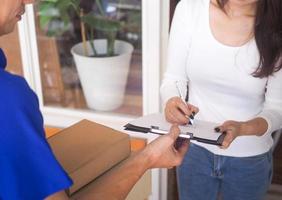 Woman signing receipt of package delivery. photo