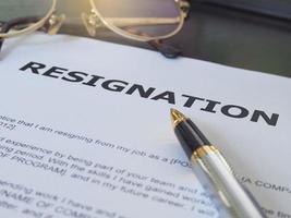 Resignation letter information with pen and glasses. photo