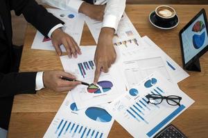 Brainstorming stock market investment plans. With statistical data showing profits and income. teamwork concept photo
