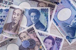 Japanese yen notes and Japanese yen coins for money concept background photo