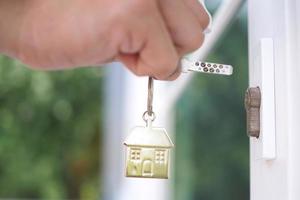 Landlord unlocks the house key for new home photo