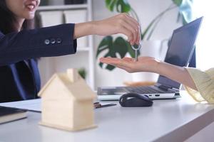 House sales staff send home keys to buyers. Buying a house in a village project photo