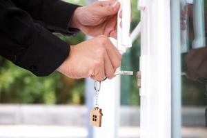 Landlord unlocks the house key for new home photo