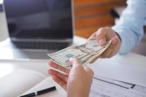 People holding money to pay interest to bank employees. Pay cash photo