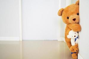 Teddy bear group standing behind the wall. Hide the secret of children. Background for Kids Games photo
