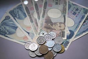 Japanese yen notes and Japanese yen coins for money concept background photo