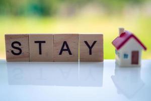 letters on the wooden blocks are arranged in the word STAY to join the campaign so everyone stays at home, not outside. During the spread of the covid19 virus. photo