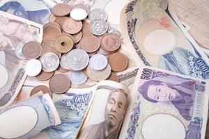 Japanese yen notes and Japanese yen coins for money concept background photo