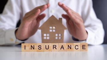 Wooden letters written insurance to protect the home and the whole family. photo
