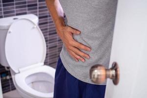 Men with stomachache, wanting to stool. Concept of stomachache, diarrhea, stomach disease photo