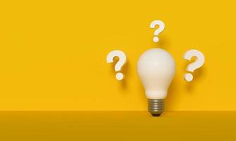 Question marks and a light bulb on yellow background. Innovation and new ideas concept. photo