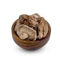 dry shiitake mushrooms in wooden bowl isolated on white background ,include clipping path photo