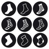 conjunto de iconos de calcetines y medias navideñas. blanco sobre un fondo negro vector