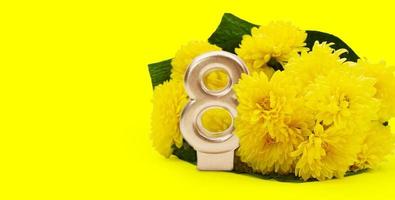 Bouquet of yellow chrysanthemums with golden number 8 with space for text. International Women's Day, March 8, birthday. Copy space photo