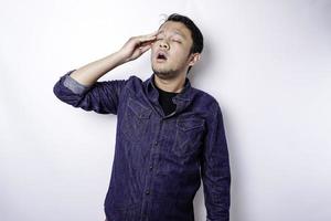 A portrait of an Asian man wearing a blue shirt isolated by white background looks depressed photo