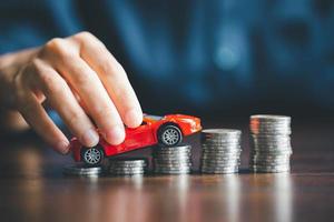 Concept of car insurance business, saving buy - sale with tax and loan for new car. Car toy vehicle with stack coin money on background. Planning to manage transportation finance costs. loan for car photo