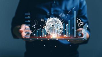 Big data analytics and business intelligence concept. Business person holding Global network connection. World map point and line composition of global business. Digital link tech. modern strategy. photo