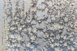 sunlit frost on surface on home window glass photo