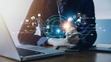 Cybersecurity and privacy concepts to protect data. Lock icon and internet network security technology. Businessman protecting personal data on smart phone with virtual screen interfaces. photo