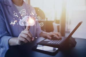 man use Laptop with cloud computing diagram show on hand. Cloud technology. Data storage. Networking and internet service concept. photo