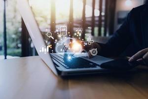 man use Laptop with cloud computing diagram show on hand. Cloud technology. Data storage. Networking and internet service concept. photo