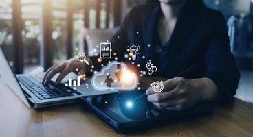 man use Laptop with cloud computing diagram show on hand. Cloud technology. Data storage. Networking and internet service concept. photo