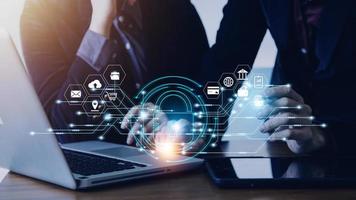 Cybersecurity and privacy concepts to protect data. Lock icon and internet network security technology. Businessman protecting personal data on smart phone with virtual screen interfaces. photo
