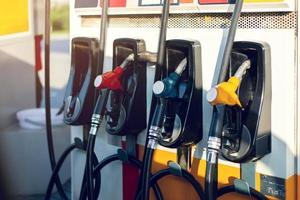 Dirty fuel nozzle in oil dispenser with gasoline and diesel in service gas station pump photo