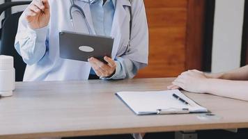 Homecare nursing service and elderly people cardiology healthcare. Close up of young hispanic female doctor nurse check mature caucasian man patient heartbeat using stethoscope during visit video