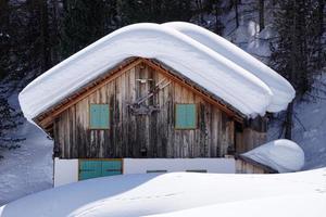 Wood cabin hut in the winter snow background photo