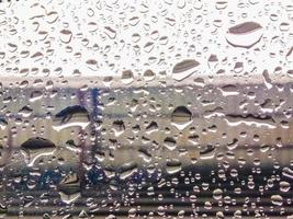 Raindrops on blurred glass background, rainy season concept, weather forecast, meteorological department, bad weather. Cold weather. photo