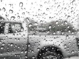 Raindrops on blurred glass background, rainy season concept, weather forecast, meteorological department, bad weather. Cold weather. photo