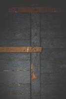 Close up battered wooden door from internal side concept photo