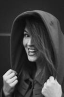 Close up joyful lady wearing stylish coat with hood monochrome portrait picture