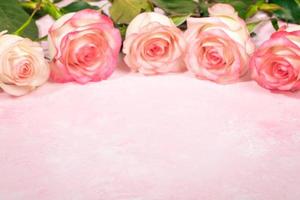 Bouquet of beautiful gentle pale pink roses on textured pink background. Festive mock up. Copy space photo