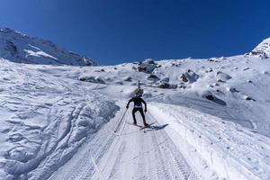 Skin skier in dolomites snow panorama photo