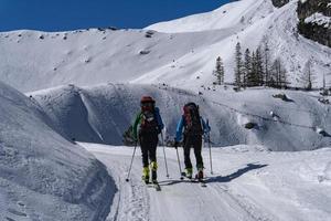 Skin skier in dolomites snow panorama photo