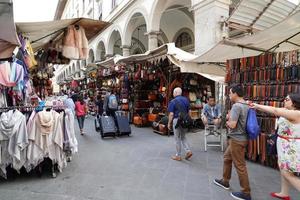 florencia, italia - 1 de septiembre de 2018 - gente comprando en el mercado de cuero de la ciudad vieja foto