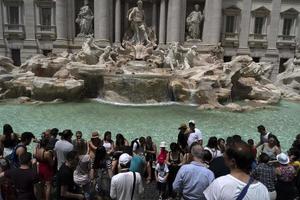 ROME, ITALY - JUNE 15 2019 - Tourist taking selfie at Fontana di Trevi fountain photo